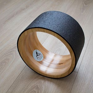 10&quot; ECO Yoga Wheel. Wooden yoga wheel. Wheel covered with black yoga mat. Wooden circle