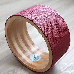 ECO Wooden Yoga Wheel covered with red yoga mat