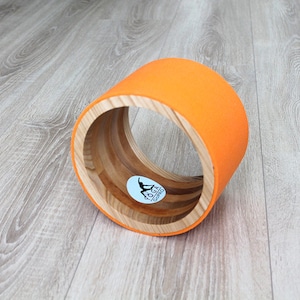 8&quot; ECO Yoga Wheel. Wooden yoga wheel. Wheel covered with orange yoga mat. Wooden circle