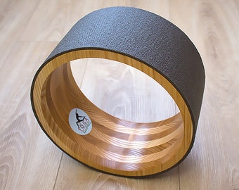 ECO Wooden Yoga Wheel covered with gray yoga mat