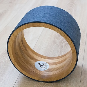 10&quot; ECO Yoga Wheel. Wooden yoga wheel. Wheel covered with blue yoga mat. Wooden circle