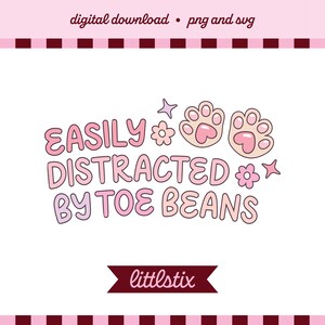 May include: A digital download graphic featuring the text EASILY DISTRACTED BY TOE BEANS in a rounded pink font. The design includes two light pink cat paw prints with heart-shaped pads, two small flowers, and two four-pointed star icons.