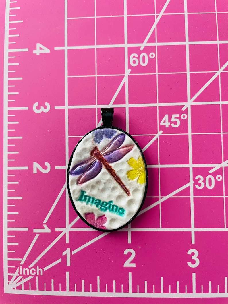 Imagine pendant with dragonfly