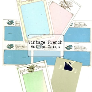 May include: A collection of vintage French button cards in various pastel colors, including blue, pink, and green. The cards feature decorative borders, dragonfly illustrations, and French text, with the words "Paris Mode" and "Nouveauté" visible.