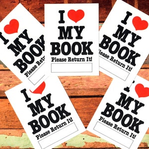 May include: Five white cards with black text and a red heart. Each card says "I love my book" and "Please return it!"