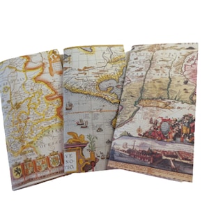 May include: Three vintage-style notebooks with covers featuring antique maps. The maps are in shades of brown, yellow, and red, with details of ships, cities, and coastlines. The notebooks are ideal for journaling, note-taking, or sketching.