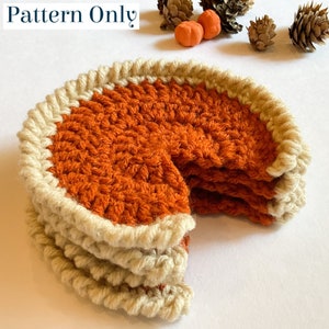 Peut inclure: Une tarte à la citrouille en crochet avec une croûte brune et un bord blanc. La tarte est coupée en tranches et empilées les unes sur les autres.