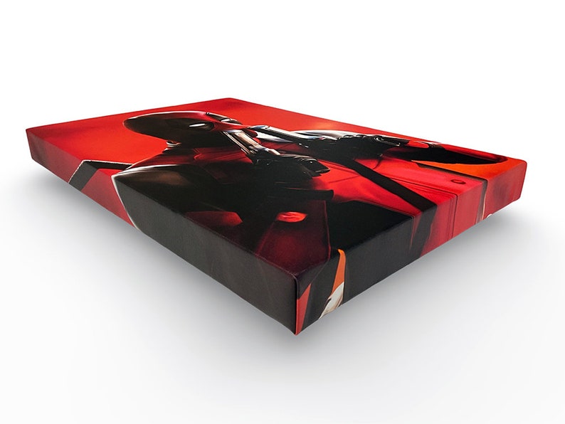 May include: A red and black canvas print featuring a superhero character with a red and black suit and a red background.
