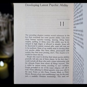 May include: Open book with the title "Developing Latent Psychic Ability" and the number 11. The text discusses psychic abilities, including developing them and the different classes of people who seek to develop them.