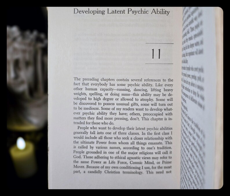 May include: Open book with the title "Developing Latent Psychic Ability" and the number 11. The text discusses psychic abilities, including developing them and the different classes of people who seek to develop them.