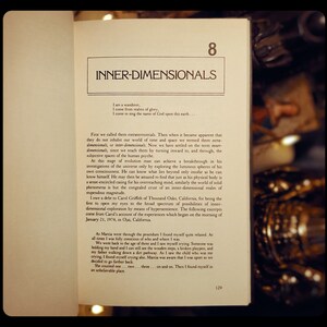 May include: Open book with a yellowed page showing the text "Inner-Dimensionals" and a passage about the concept of inner-dimensionals. The text discusses the evolution of human consciousness and the exploration of the universe through the subjective spaces of the human psyche.