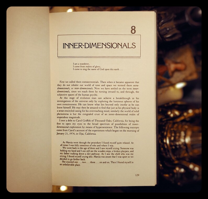 May include: Open book with a yellowed page showing the text "Inner-Dimensionals" and a passage about the concept of inner-dimensionals. The text discusses the evolution of human consciousness and the exploration of the universe through the subjective spaces of the human psyche.