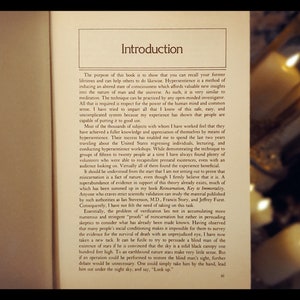 May include: A close-up of a book titled "Introduction" with text about hypersentience, a method of inducing an altered state of consciousness. The book discusses the nature of man and the universe, and the power of the human mind.