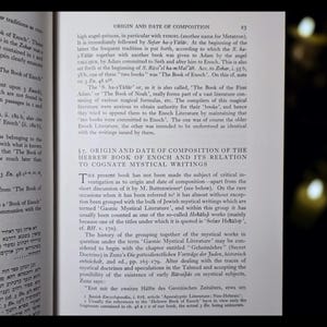 May include: An open book with text in English and Hebrew. The page shows a section titled "ORIGIN AND DATE OF COMPOSITION" with detailed text. The book appears to be a scholarly work on religious texts.