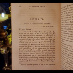 May include: A page from a book titled "The Pillar of Fire, or" with the text "Letter VI. Remeses of Damascus to King Resorthis. City of On, Egypt." The text describes a secret assembly of elders called by Moses, who met at night in a solitary place far from any of the garrisons of soldiers.