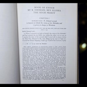 May include: An open book displaying text from "Book of Enoch" by R. Ishmael Ben Elisha, The High Priest. The page shows Chapter 1, with text about R. Ishmael's ascent to heaven and the vision of the Merkaba.
