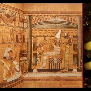 以下が含まれることがあります： 古代エジプトの壁画で、ファラオに供物が捧げられている場面が描かれている。ファラオは王座に座り、白い頭飾りをかぶり、模様のあるローブを着ている。白い頭飾りをかぶり、模様のあるローブを着た人物がファラオの前に立ち、杖を持っている。絵はベージュの背景にヒエログリフやその他の装飾的な要素が描かれている。