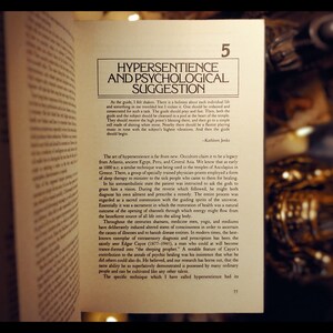 May include: A close-up of a book page with the title "Hypersentience and Psychological Suggestion." The text discusses the history of hypersentience and its use in healing.