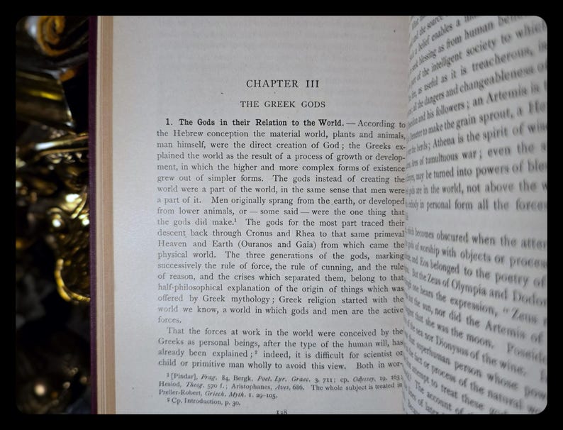 May include: A close-up of a page from a book titled "The Greek Gods". The text discusses the origin of the Greek gods and their relationship to the world. The text is in black and white.