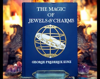 May include: A blue hardcover book titled "The Magic of Jewels & Charms" by George Frederick Kunz. The book cover features a gold globe with a white band and zodiac symbols.