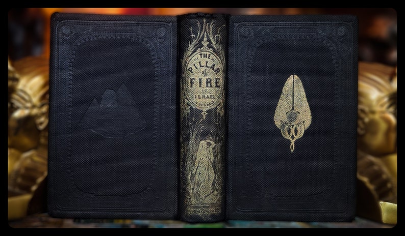 May include: A black leather-bound book with gold lettering on the spine. The title is "The Pillar of Fire" and the author is "J.H. Ingraham". The front and back covers have embossed designs.