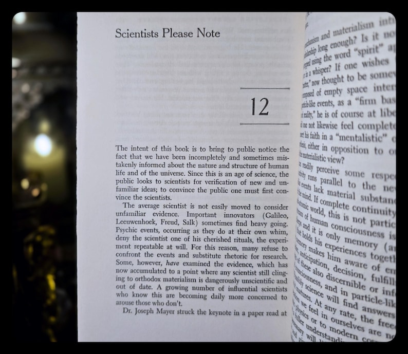 May include: Open book page with the title "Scientists Please Note" and the number "12" in bold. The text discusses scientific concepts and the nature of the universe. The book's pages are off-white.
