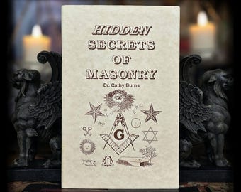 May include: A book titled "Hidden Secrets of Masonry" by Dr. Cathy Burns, featuring Masonic symbols. The book is flanked by two dark gray gargoyle statues. The background includes lit candles, creating a mysterious ambiance.