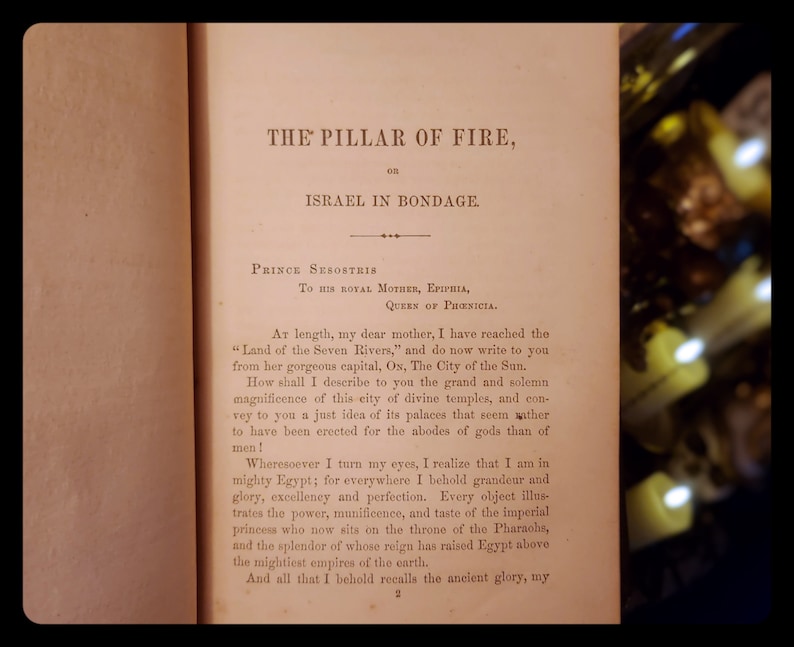 May include: A page from a book titled "The Pillar of Fire, or Israel in Bondage." The text describes the grandeur of ancient Egypt and its capital, Ox, the City of the Sun.