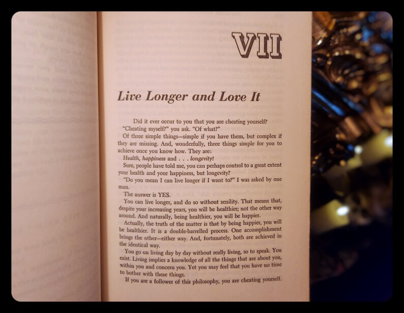 May include: A page from a book titled "Live Longer and Love It" with the text "Did it ever occur to you that you are cheating yourself?" and "The answer is YES." The text discusses the importance of health, happiness, and longevity.
