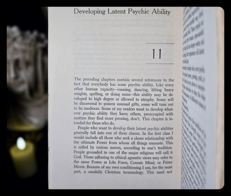 May include: Open book page with the title "Developing Latent Psychic Ability" and the number "11". The text discusses psychic abilities, their development, and different perspectives on the ultimate power. The page is set against a dark background.
