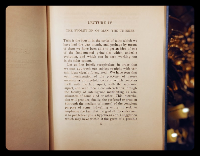 May include: A close-up of a page from a book titled "LECTURE IV THE EVOLUTION OF MAN, THE THINKER". The text discusses the concept of evolution and the interrelation of life, substance, and intelligence.