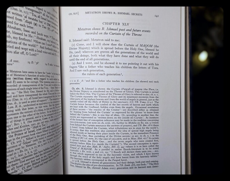 May include: An open book with text on aged paper. The text includes the chapter title "Metatron Shows R. Ishmael Secrets" and the text "Chapter XLV". The pages are yellowed with age.