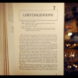 May include: A page from a book titled "Lost Civilizations" with text about the concept of "psi-reality" and the origins of creation. The text discusses how people often end up in a realm of kaleidoscopic color and sound when trying to go back as far as possible in time.