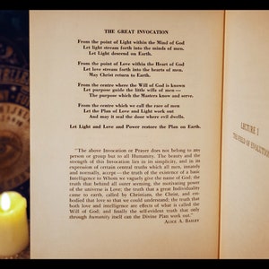 May include: A vintage book with a yellowed page featuring a text titled "The Great Invocation". The text is a prayer or invocation for peace and light. The book is open and the pages are slightly curled at the edges.
