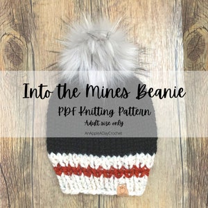 May include: Black and white knit beanie with a red and white stripe pattern. The beanie has a faux fur pom pom on top and the text "Into the Mines Beanie PDF Knitting Pattern Adult size only AnAppleADayCrochet" is printed on a white background.