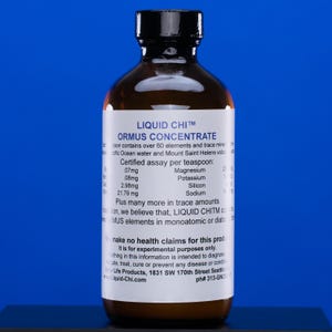 May include: A brown glass bottle with a black cap, labeled "LIQUID CHI™ ORMUS CONCENTRATE." The label lists mineral content per teaspoon, including magnesium, potassium, silicon, and sodium. The bottle is against a blue background.