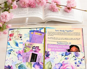 May include: A Bible study journal with a floral design featuring purple and blue roses. The journal includes pockets with notes and cards, and the text "Let's Study Together!" and "Unlocking the Power of Scripture:" are visible.