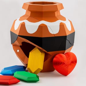 May include: A low-poly orange pot with a white scalloped rim and a black horizontal band. The pot has a large opening from which a yellow crystal emerges. Beside the pot are a red heart, a red crystal, a green crystal, and a blue crystal.