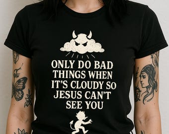 May include: Black t-shirt with a white graphic of a devil in a cloud with the text "Only do bad things when it's cloudy so Jesus can't see you".