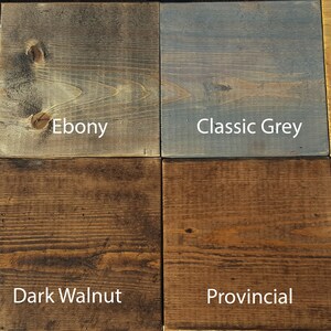 May include: Eight wood stain samples, showing different shades of brown, red, gray, and yellow. The stains are labeled: Red Mahogany, Ebony, Classic Grey, Golden Oak, Jacobean, Dark Walnut, Provincial, and Special Walnut.