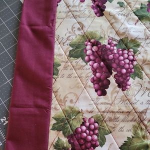 May include: A set of three ceramic mugs with a speckled, matte finish. The mugs are in shades of cream, light gray, and dark gray. Each mug has a simple, minimalist design and a rounded handle.