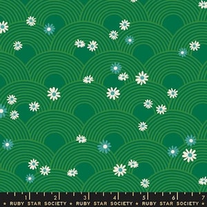 May include: A green fabric featuring a repeating pattern of concentric semicircles in a lighter shade of green, interspersed with small white and light blue daisy-like flowers. A black selvage edge at the bottom displays the text Ruby Star Society.