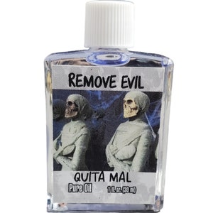 May include: A clear glass bottle with a white cap containing oil. The label features the text REMOVE EVIL and QUITA MAL, along with the words Pure Oil and 1 fl. oz. (30 ml). The label displays two mummified figures with skulls against a dark background.
