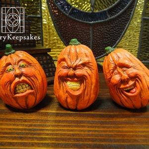 Carved Pumpkins, Smiling, on a Table Out of Doors Facing and Side
