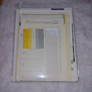 May include: A close-up of a graph with a yellow and gray color scheme. The graph is labeled "Magnolia Grandiflora Trees" and has a handwritten note that says "Feed in the month of June".
