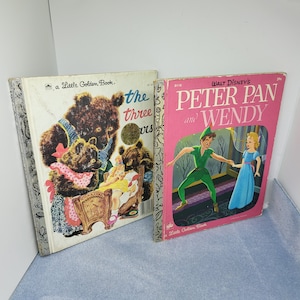 May include: Two vintage Little Golden Books. One book features a cover with brown bears and the title "The Three Bears." The other book is pink and features Peter Pan and Wendy, with the title "Peter Pan and Wendy."