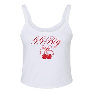 May include: White tank top with a red graphic of two cherries with a bow and the text "GG-Big".