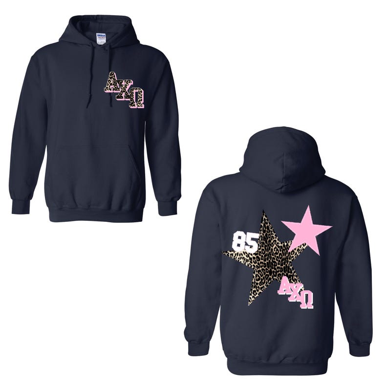 May include: Navy blue hooded sweatshirt with a pink and leopard print star design on the back. The front features the Greek letters &Alpha;&Chi;&Omega; in a leopard print design. The number 85 is also visible.