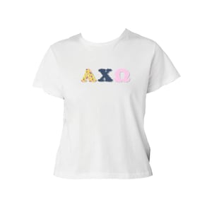 May include: White t-shirt featuring the Greek letters AXΩ. The letters are in floral, navy blue, and pink gingham patterns. The shirt has a crew neck and short sleeves. The letters are embroidered.