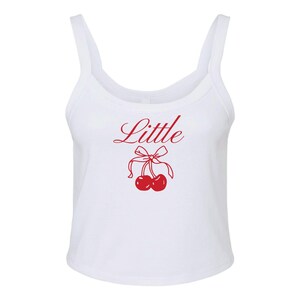May include: White tank top with a red cherry graphic and the word "Little" in red cursive.
